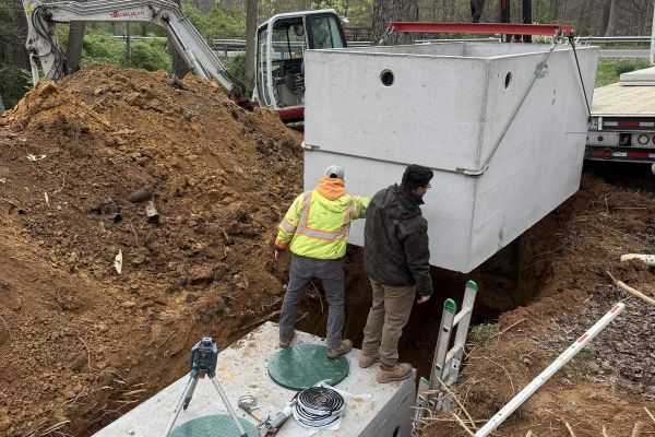Septic tank installation site workers digging and progress