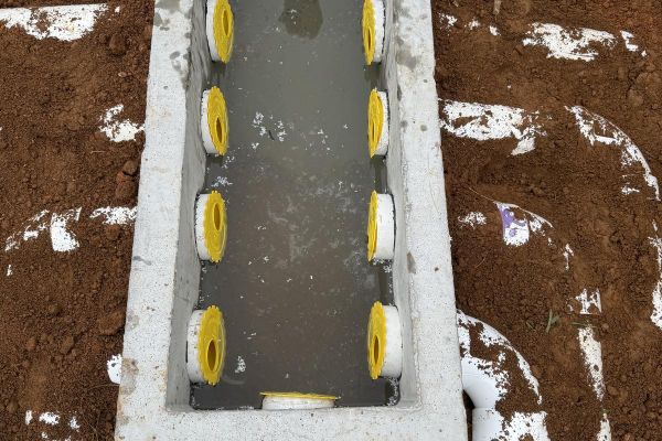 Septic installation pipes and gravel in ground worksite