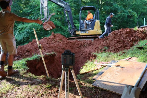 Digging a hole for septic system installation in progress